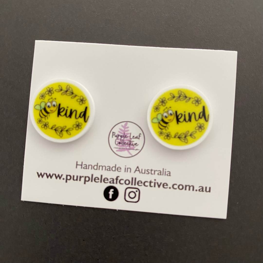 Bee Kind Stud Earrings approx 14mm with a picture of a bee and the word kind. Handmade with hypoallergenic surgical steel posts, safe for sensitive ears.
