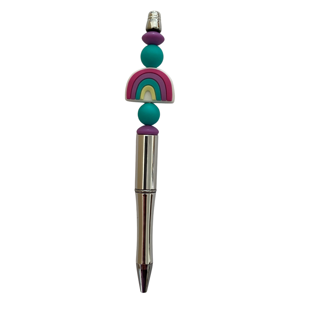 Pen with colorful bead decorations on a white background.