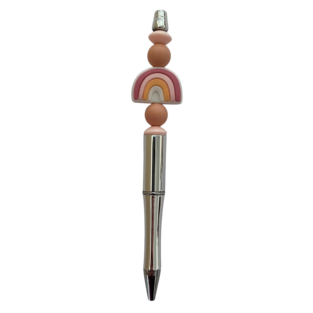 Decorative pen with peach rainbow beads on a white background.