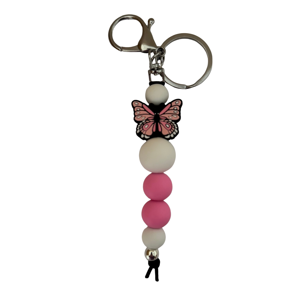 An 18cm keyring featuring a pink butterfly silicone bead and white and pink round silicone beads.