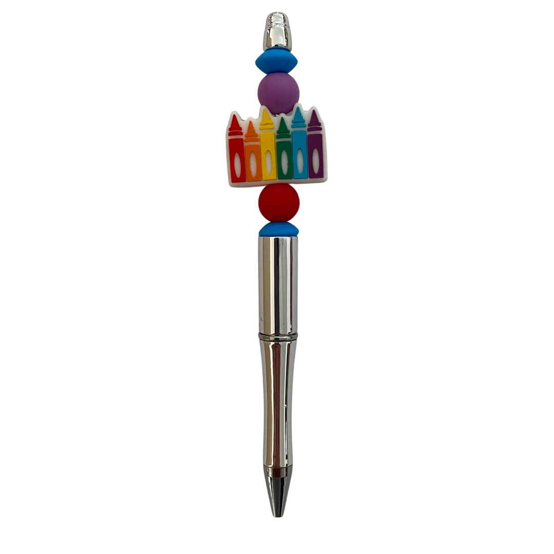 A black ink refillable pen with a six crayons in the colours of the rainbow silicone bead on top.