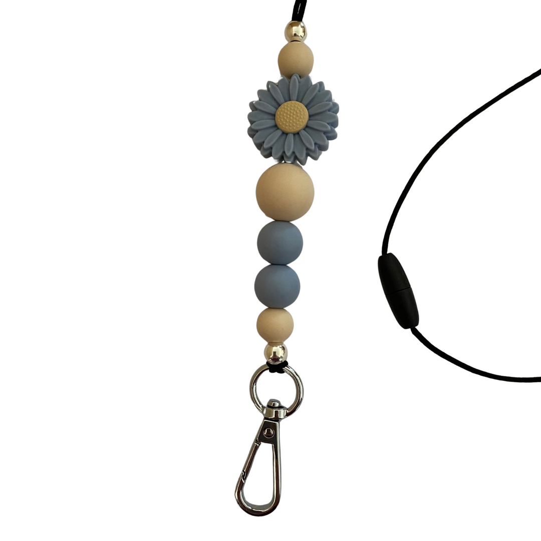 A 60cm lanyard fitted with a safety break away clasp and a Daisy Dusky Blue silicone bead and other coloured round silicone beads.