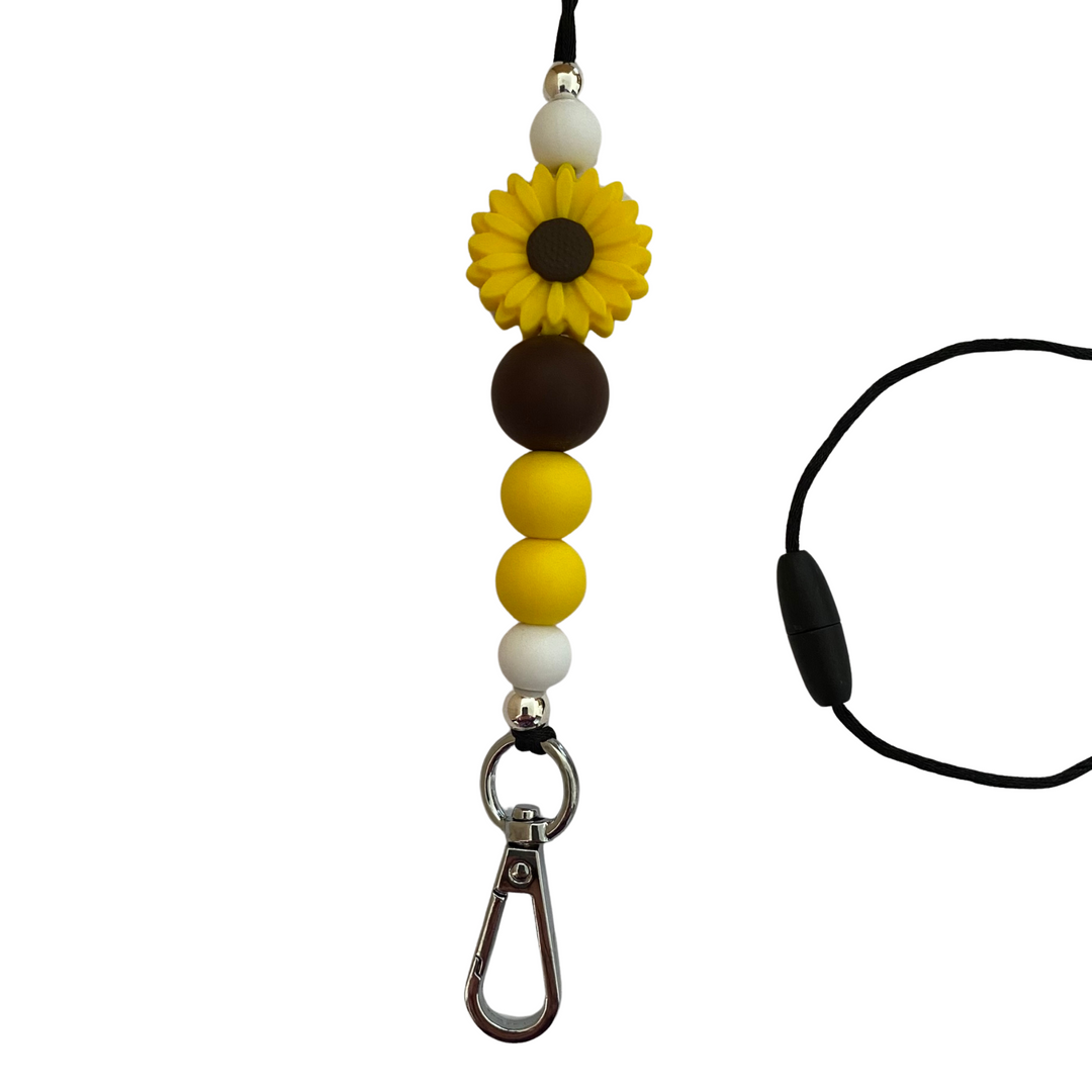 A 60cm lanyard fitted with a safety break away clasp and a Daisy Yellow and White silicone bead and other coloured round silicone beads.