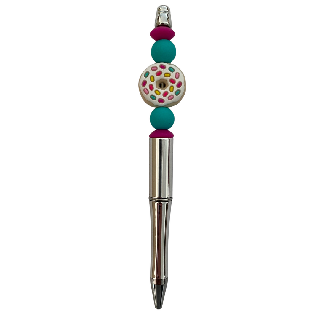 A black ink refillable pen with iced donut with sprinkles silicone bead on top.