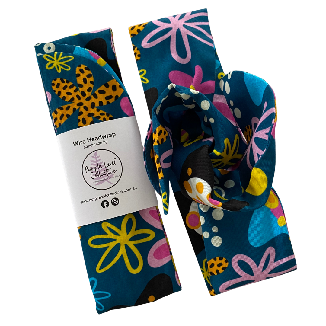 Handmade wire headwrap, headband with colourful flowers set on dark blue colour fabric by Kasey Rainbow. Stylish, adjustable, and perfect for all-day wear or hair loss coverage.