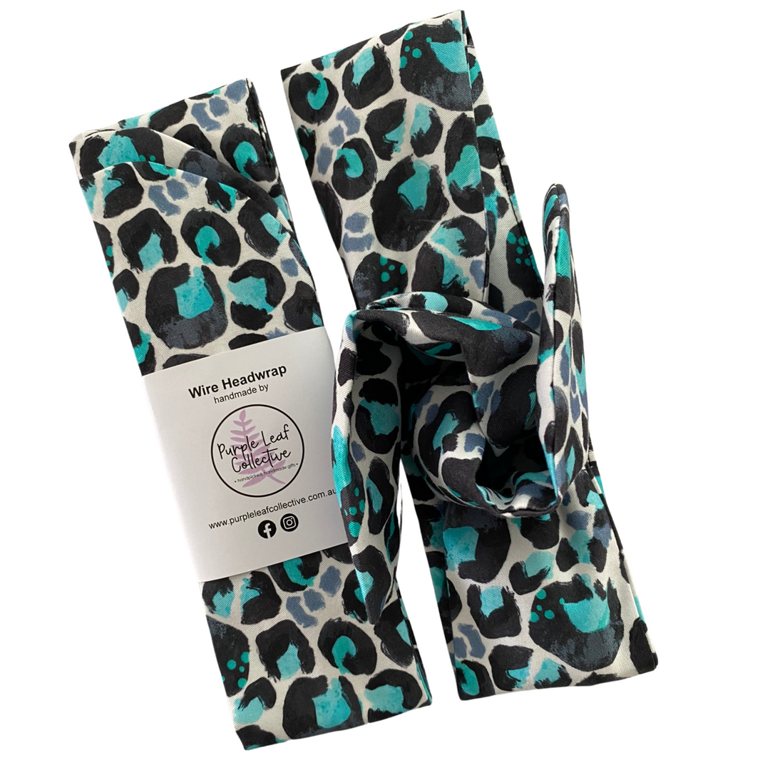 Leopard print headwrap with a visible brand label on a white background.