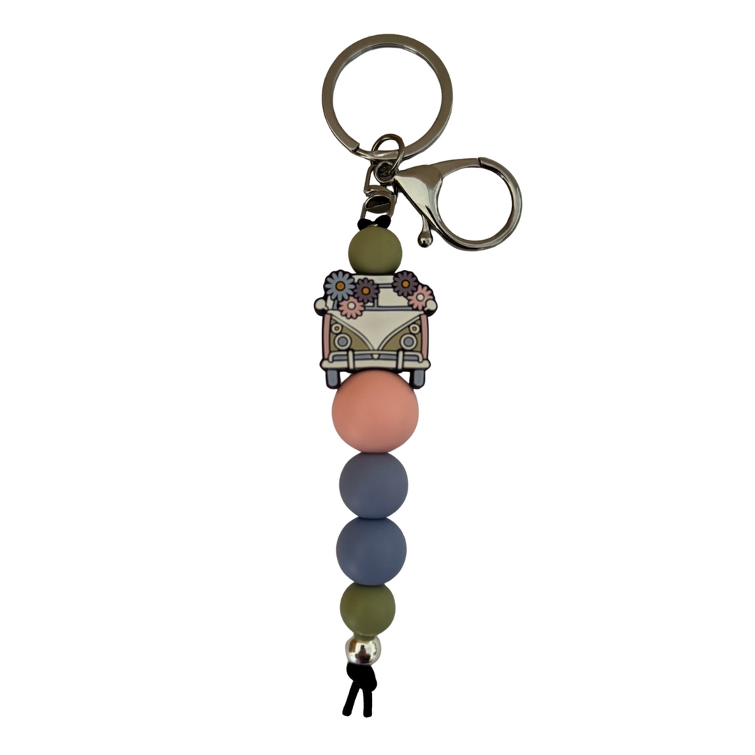 Keychain with colourful beads and a kombi vehicle bead on a white background.