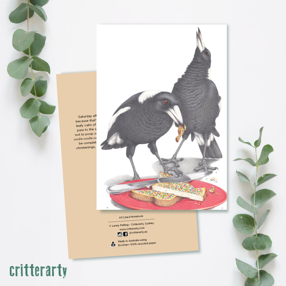 A5 premium lined notebook with 80 pages, luxuriously bound in a silky smooth, full colour cover featuring a pair of Magpies eating fairy bread.