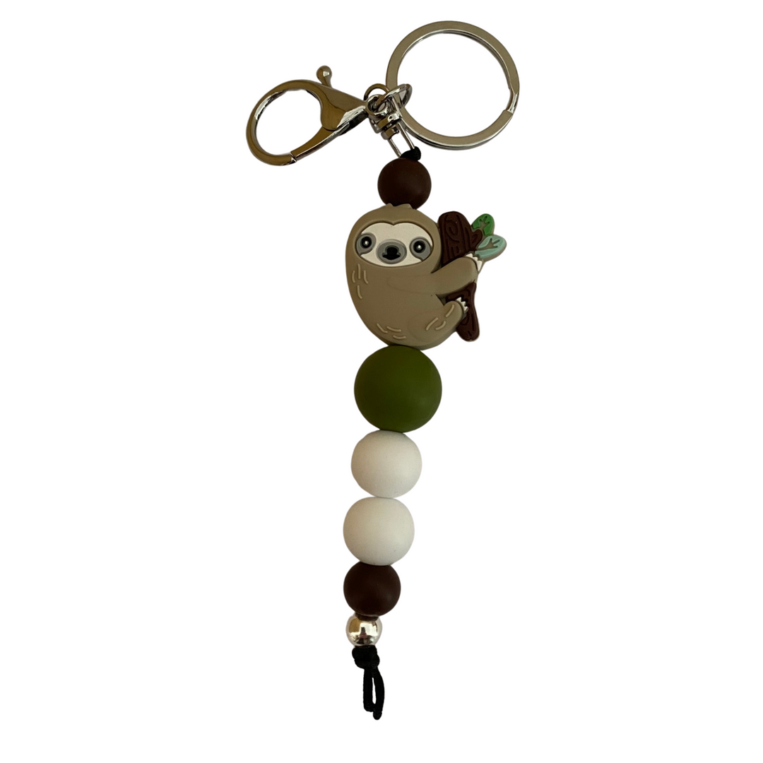 A keyring featuring a sloth silicone bead and other round coloured silicone beads.