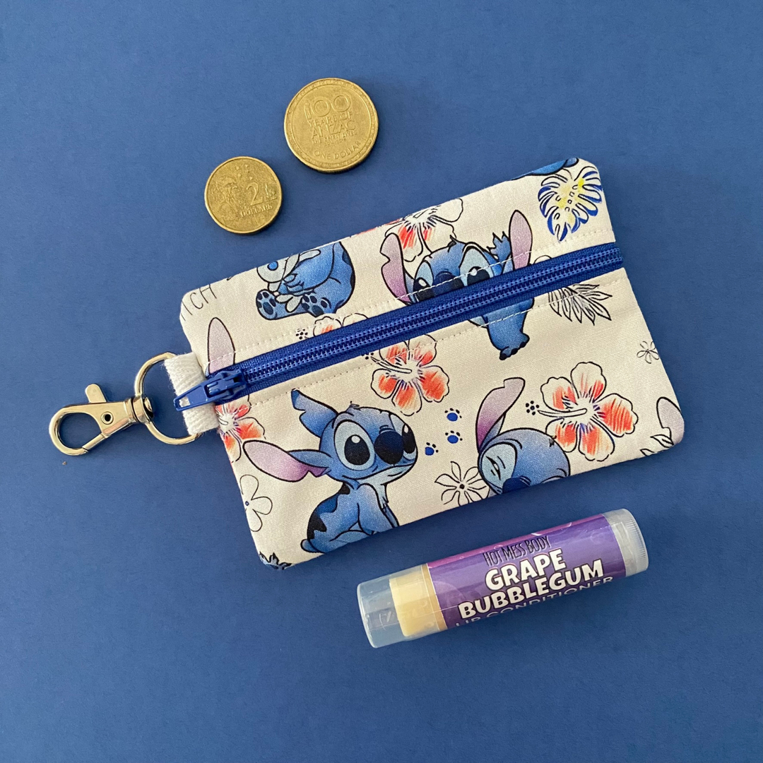 A small clip coin purse perfect for coins and small essentials featuring Stitch and flowers fabric.