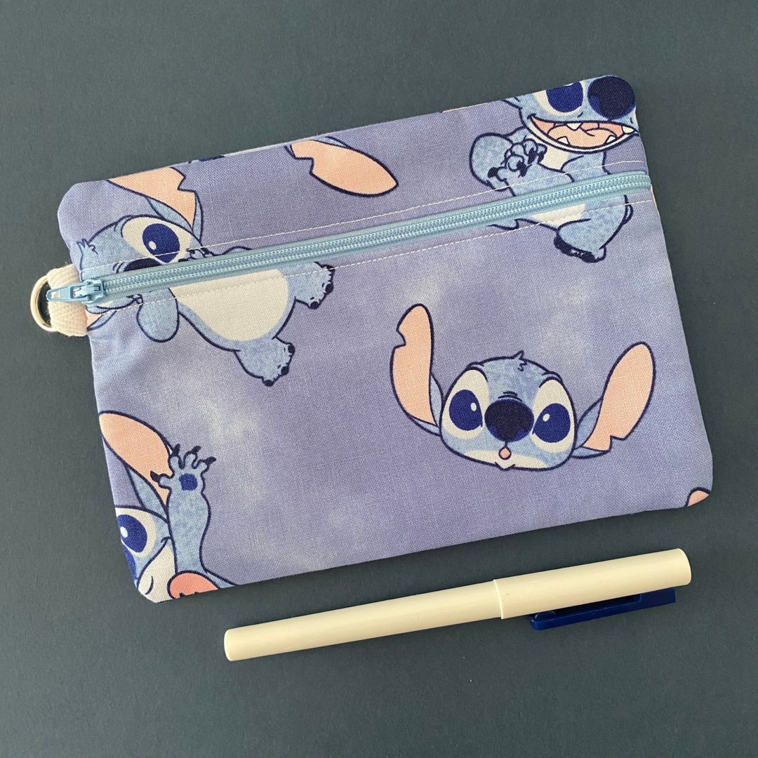 Zipper pouch with images of Stitch on a watercolour fabric. Planner accessory for school or work. Perfect for small essentials.