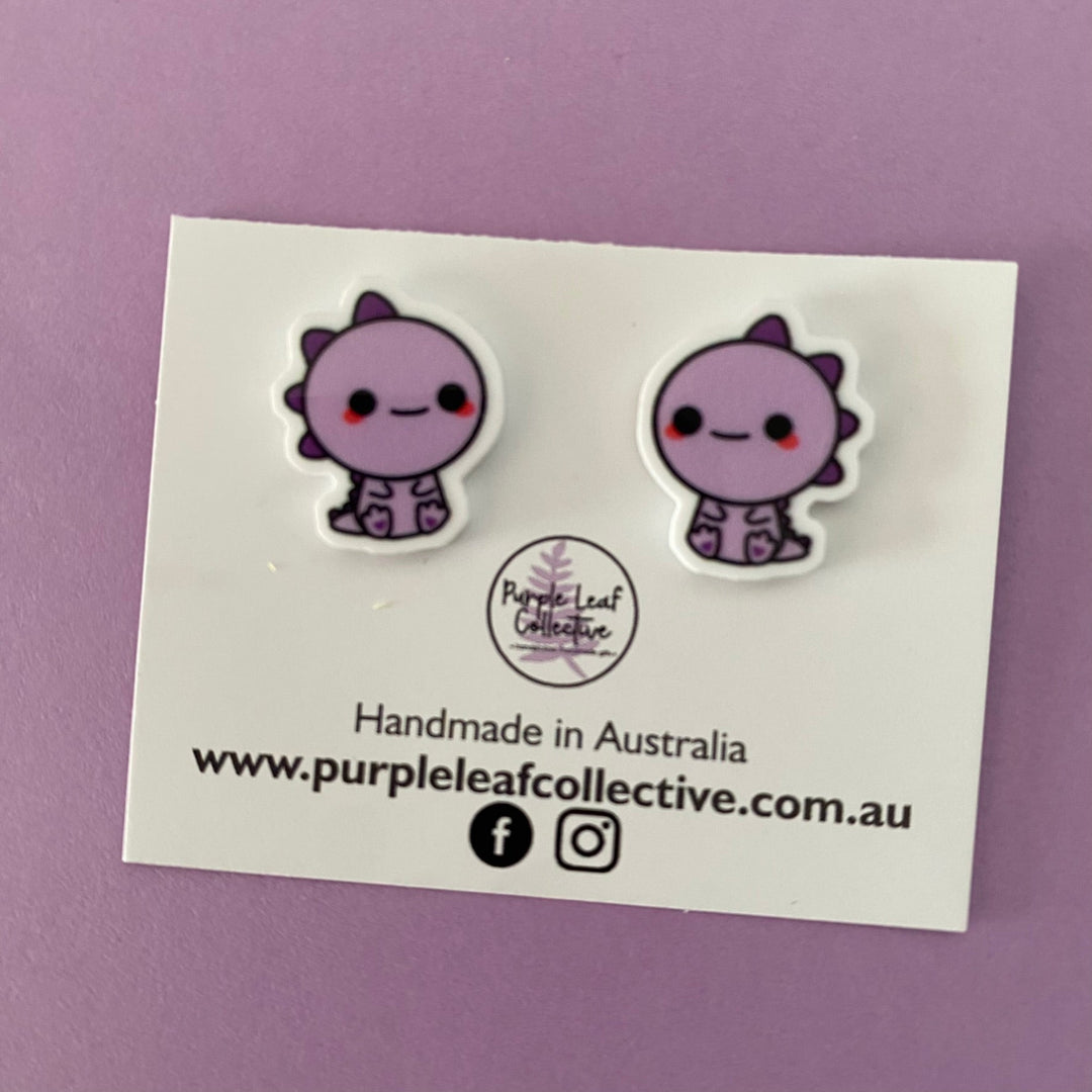 Purple T-Rex Dinosaur novelty stud earrings. Hypoallergic Surgical Steel Posts. Printed Acrylic. Approx 15mm.