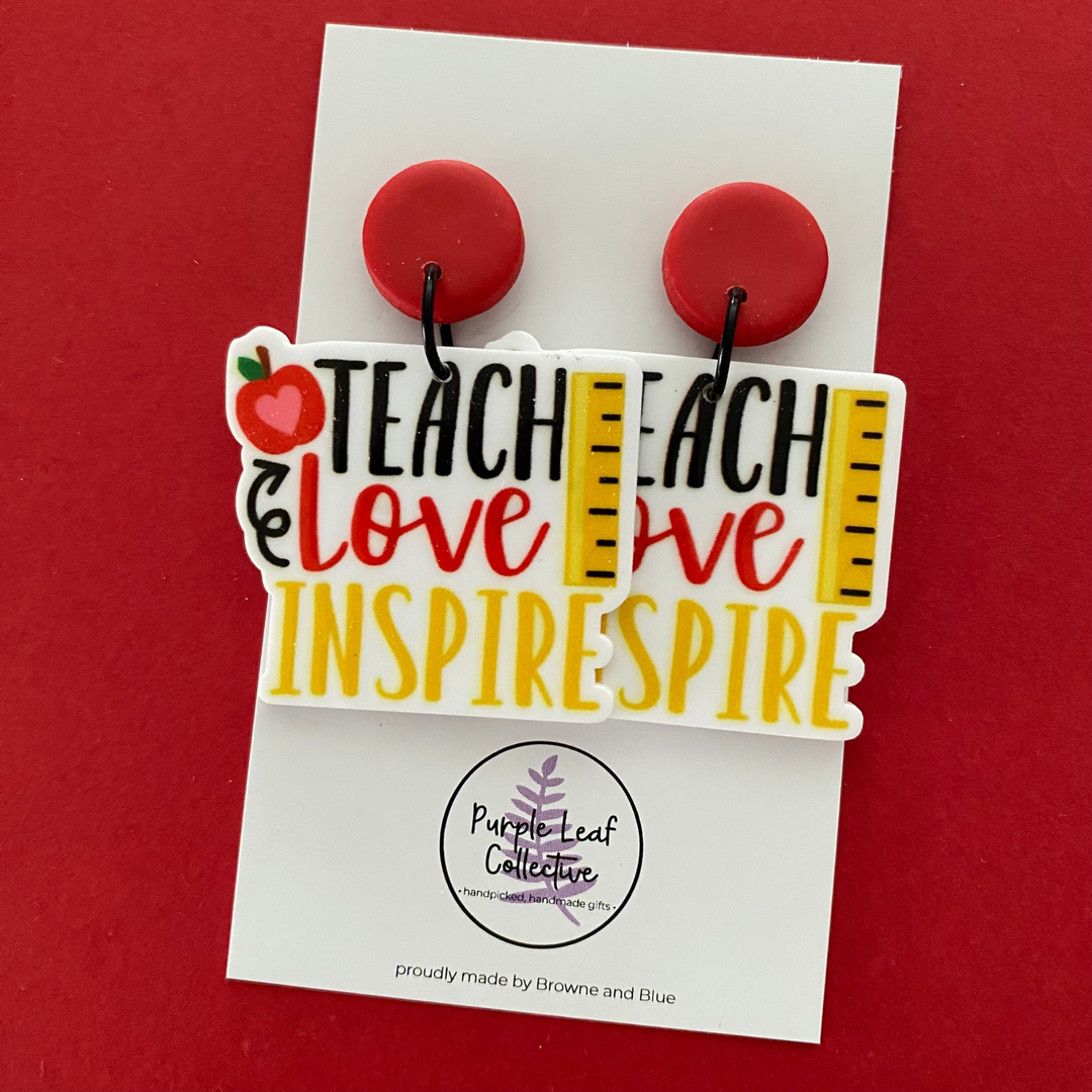 Teach Love Inspire worded Stud Dangle Earrings with images of a red apple and ruler and black outline with a red stud top. Approx 5cm in length. Made with hypoallergic Surgical Steel Posts.