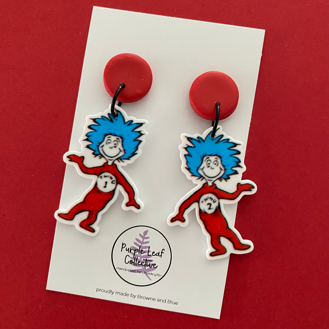 Images of Thing 1 and Thing 2 Stud Dangle Earrings with with blue hair and red bodies with a red stud top. Approx 5.5cm in length. Made with hypoallergic Surgical Steel Posts.