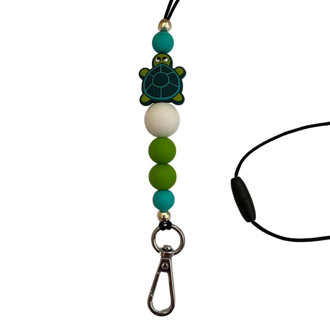 A 60cm lanyard fitted with a safety break away clasp featuring a turtle silicone bead and other coloured round silicone beads.