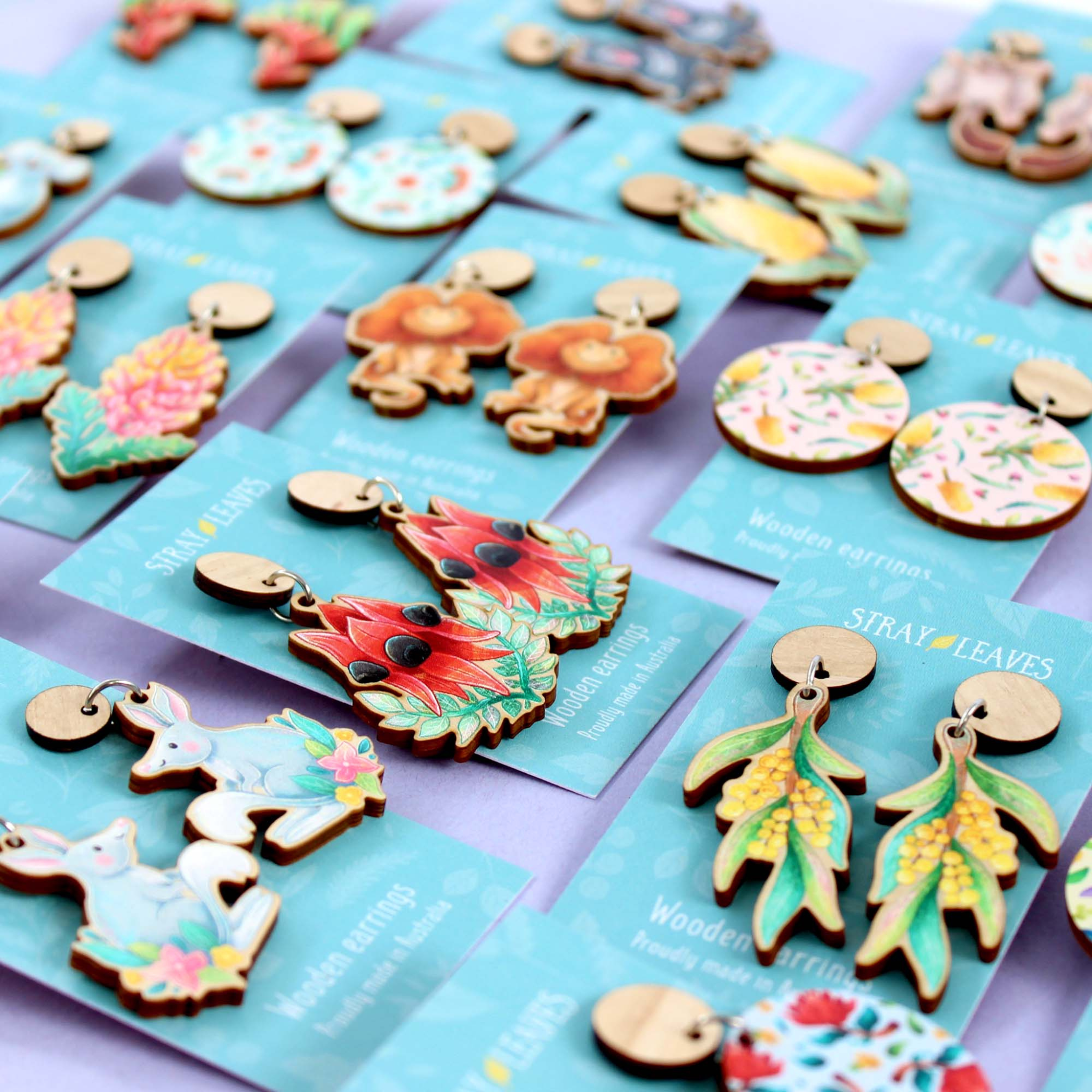 Images of our wooden stud dangle earrings featuring Australian critters and flora.