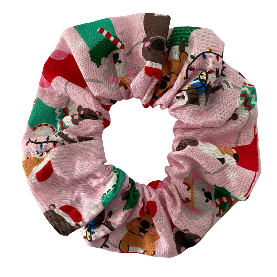 Multicolored scrunchie with Christmas-themed design on a white background.