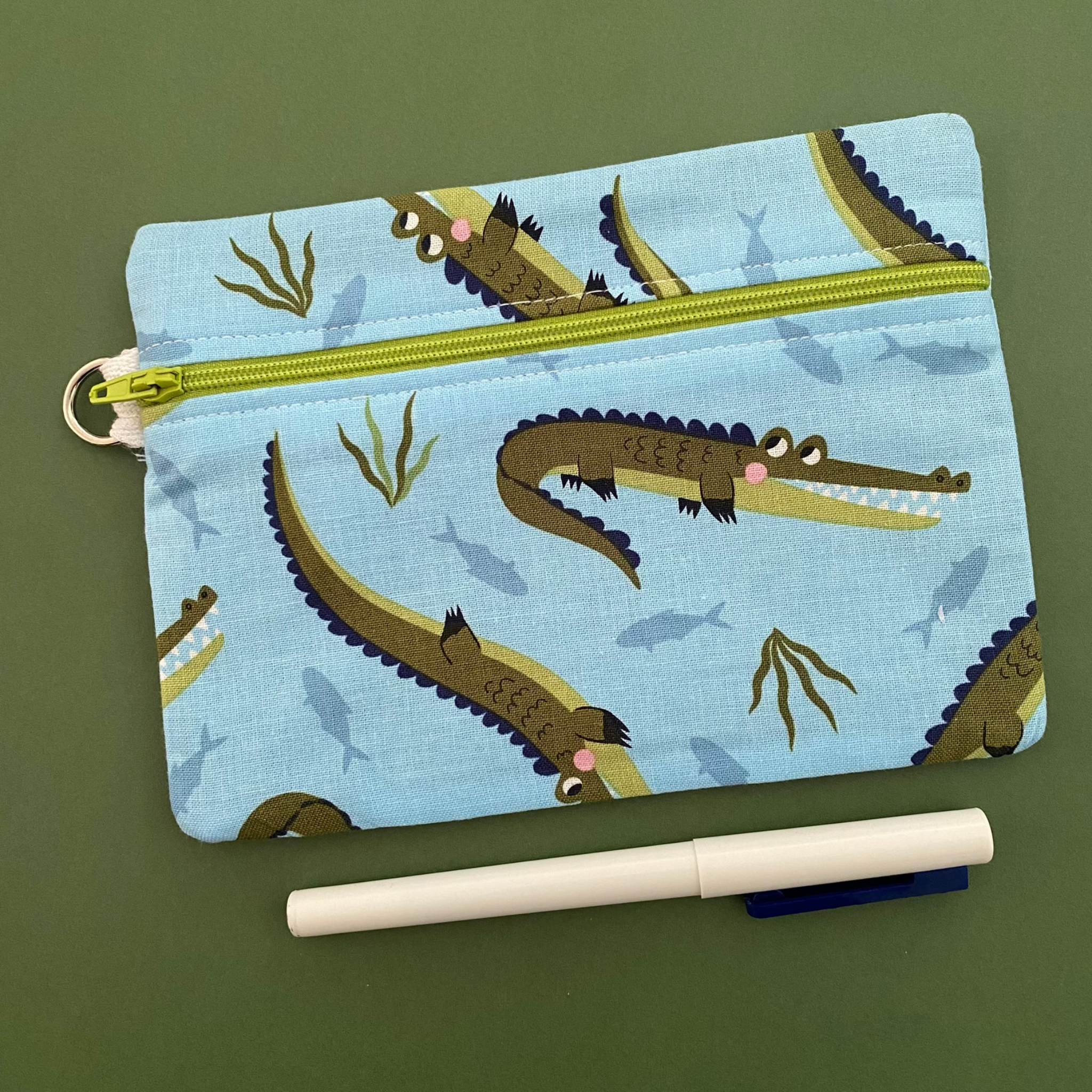 A medium zipper pouch with images of Crocodiles.
