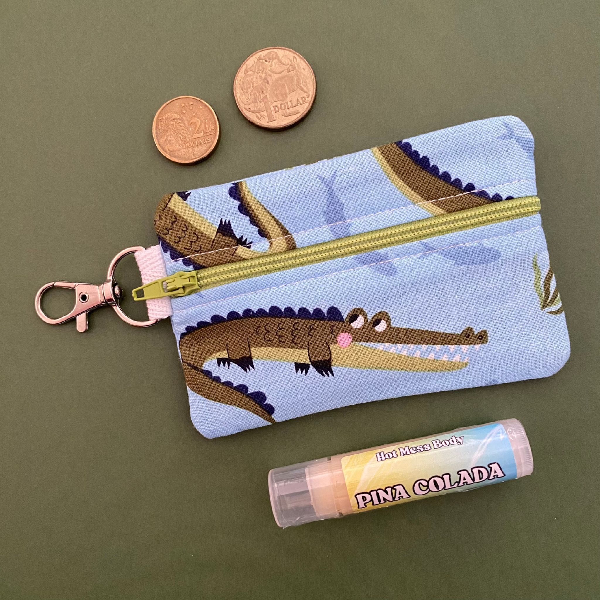 A clip coin purse with images of Crocodiles.