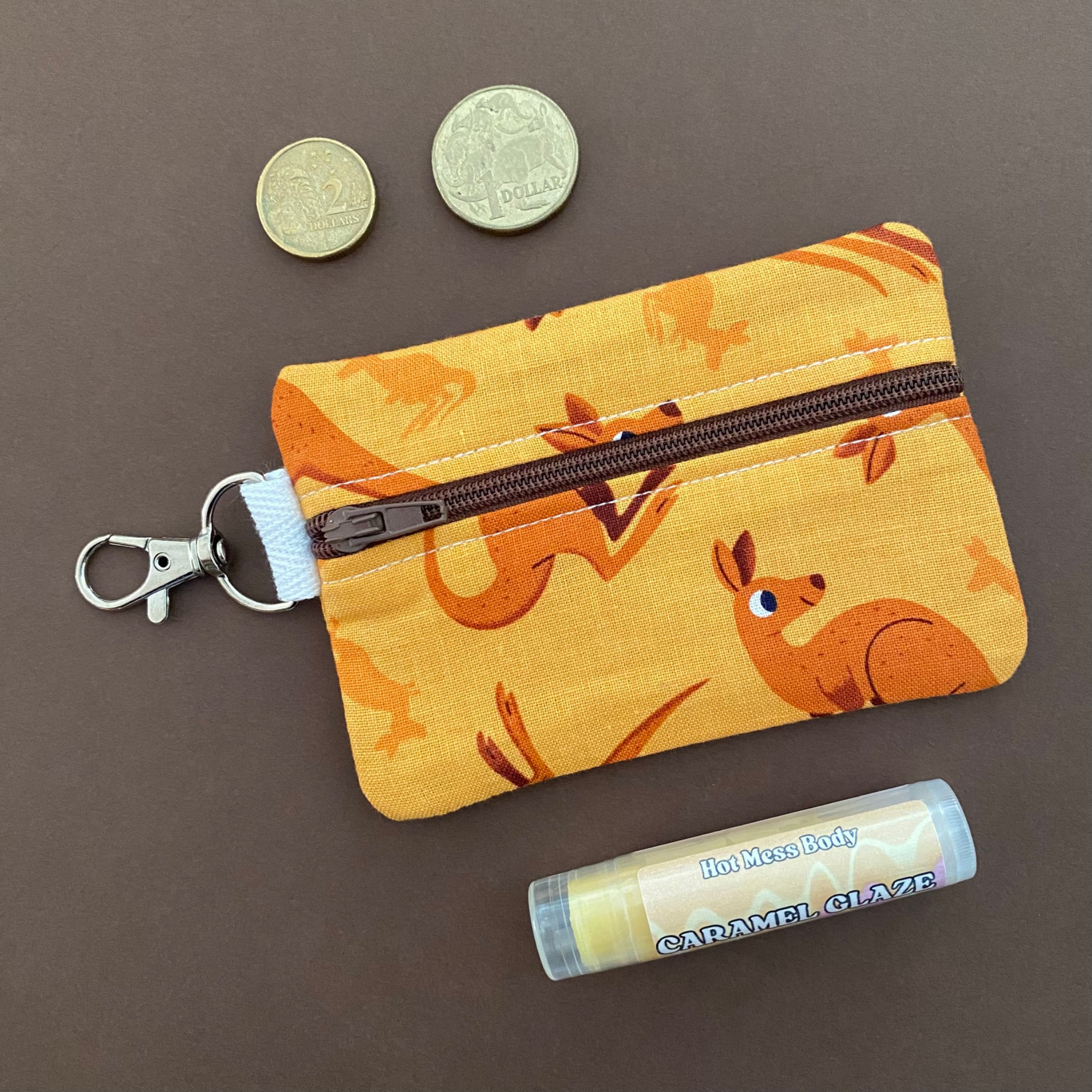 A clip coin purse featuring images of Kangaroos and Joeys.