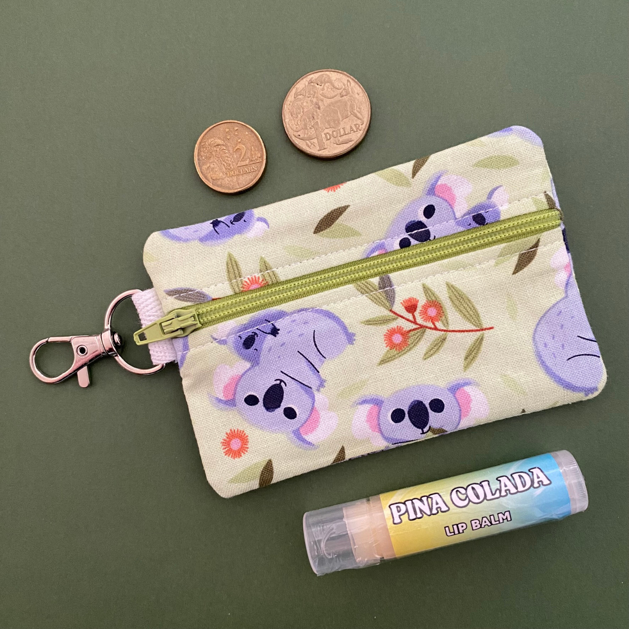 A clip coin purse featuring images of Koalas and their joeys.