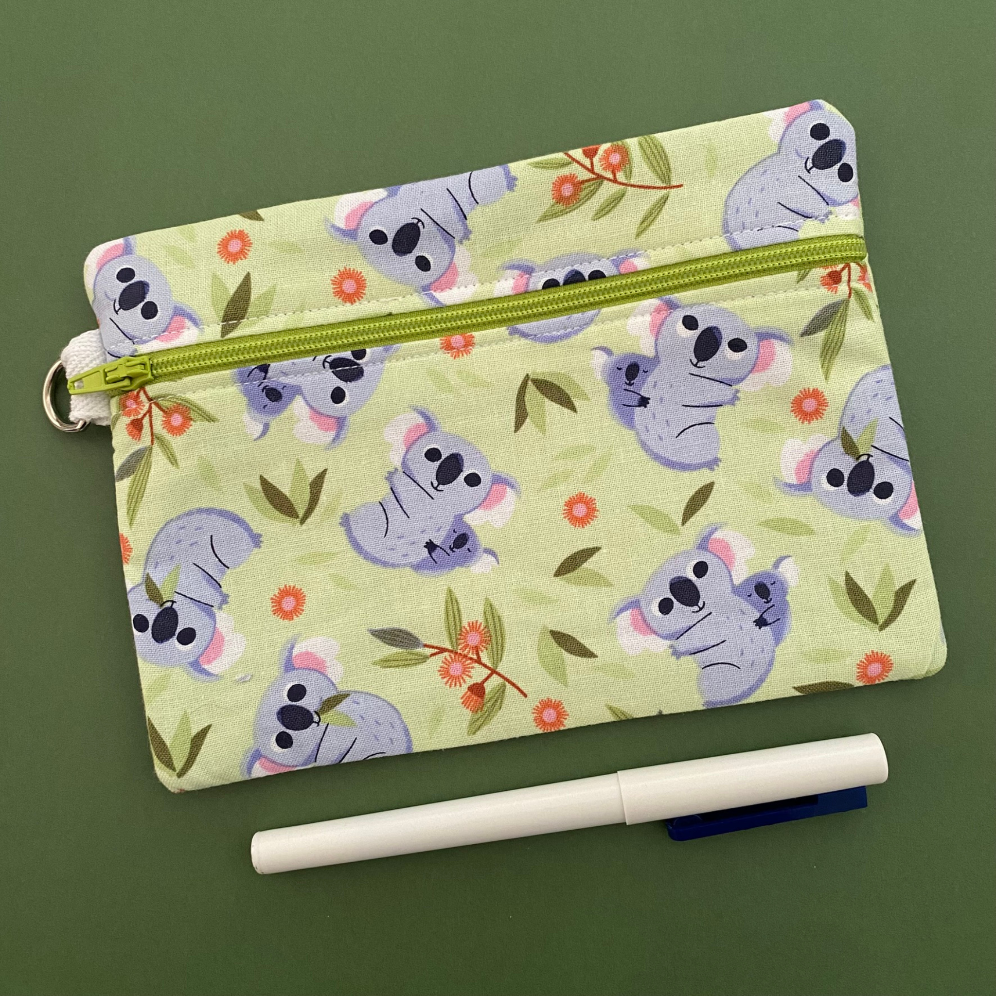 A medium zipper pouch with images of Koalas and Joeys.