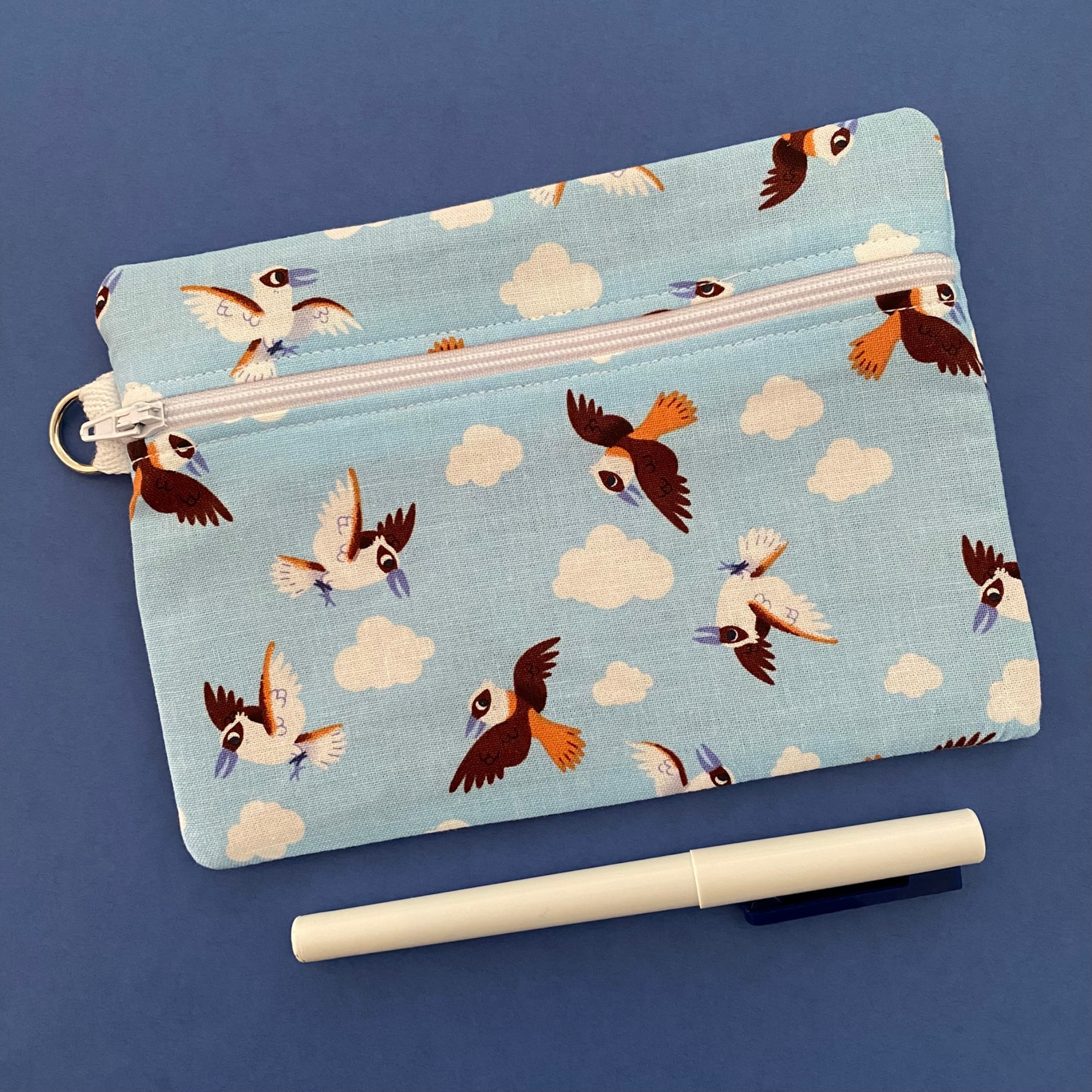 A zipper pouch featuring images of flying Kookaburras.