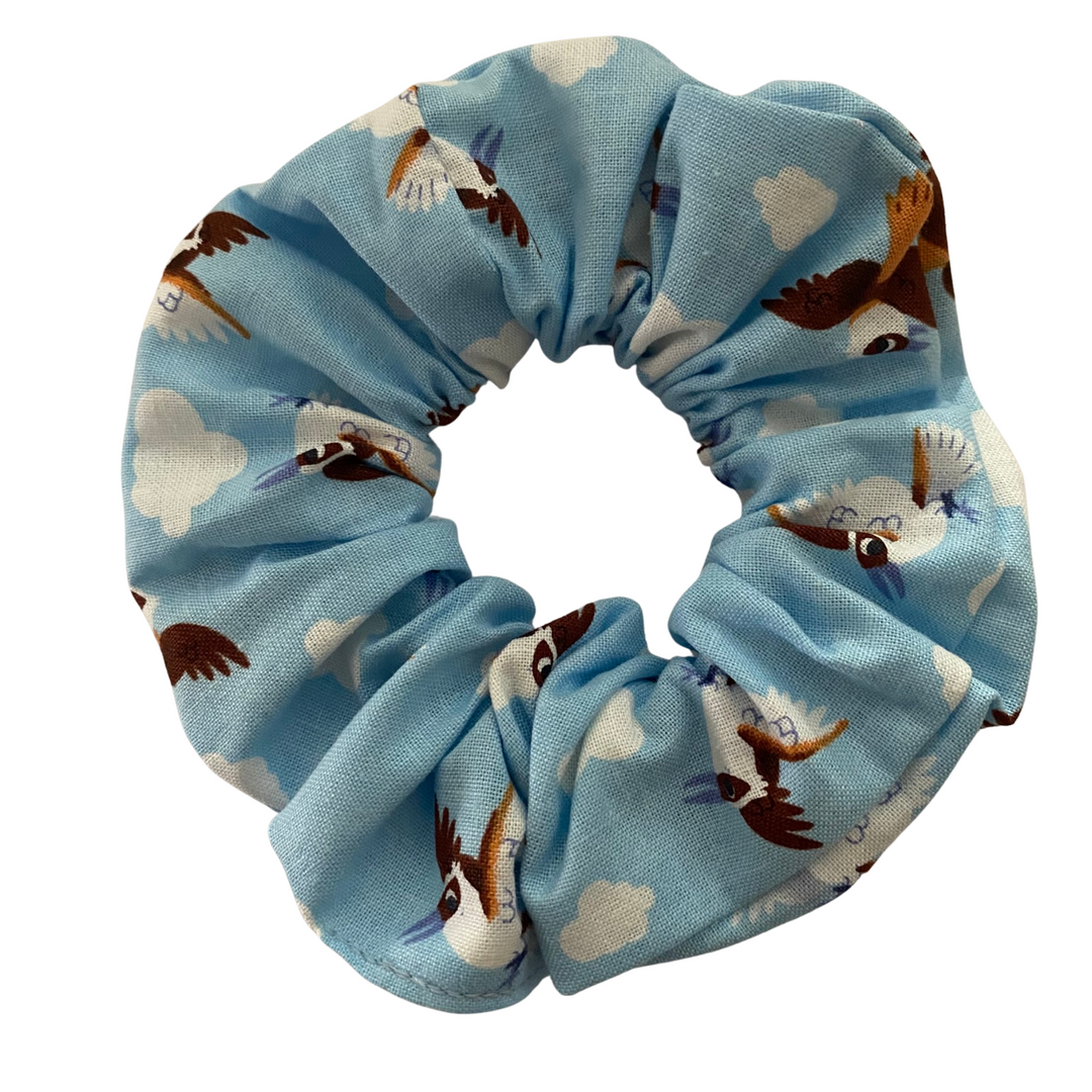 A light blue coloured fabric featuring images of cute Kookaburras.