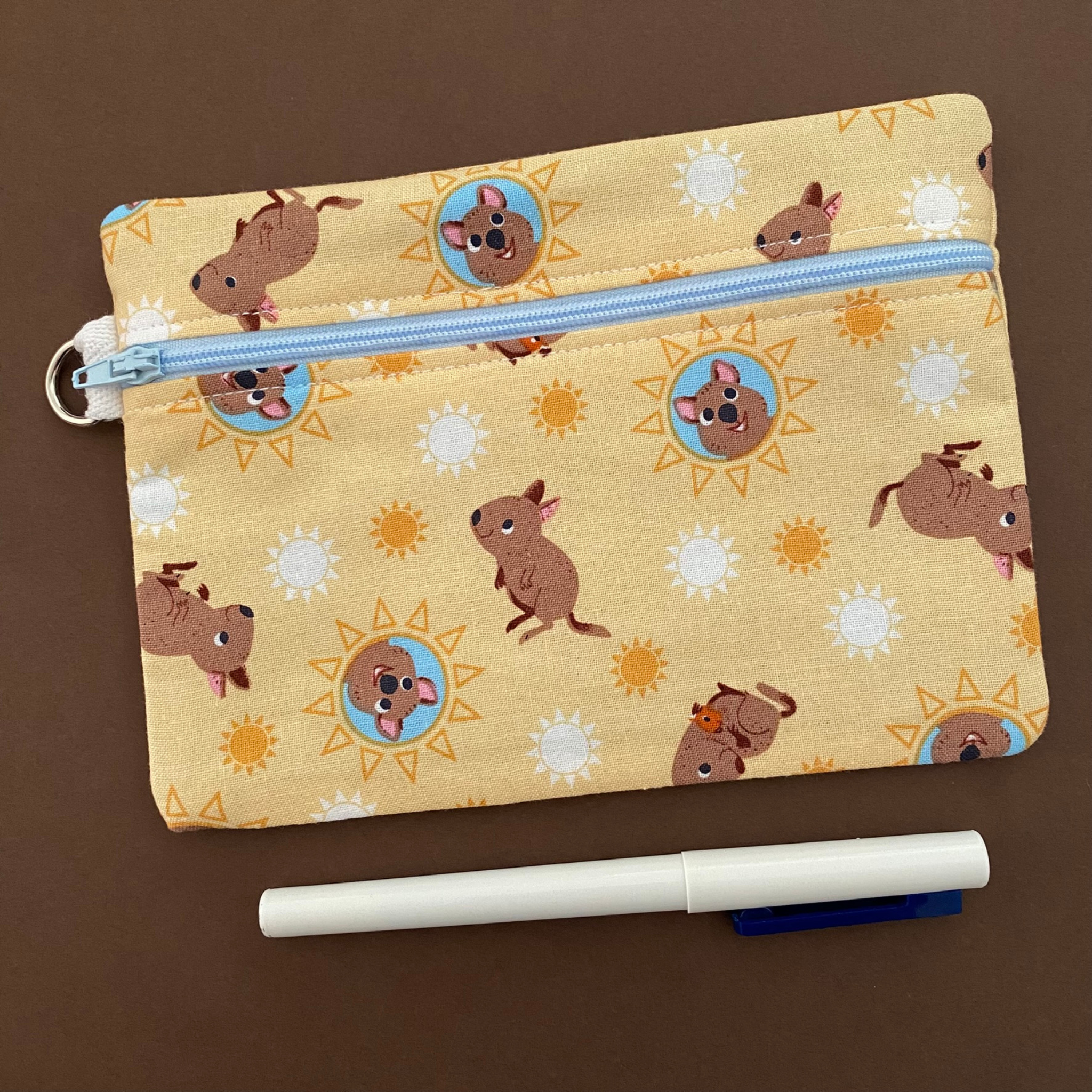 A medium zipper pouch featuring images of Quokkas.