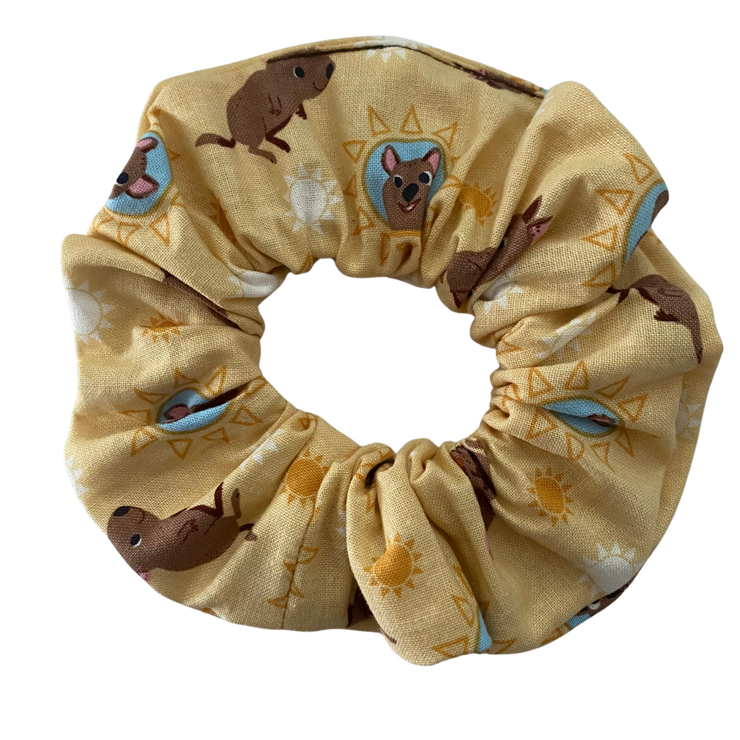 A light mustard coloured fabric featuring images of cute Quokkas.
