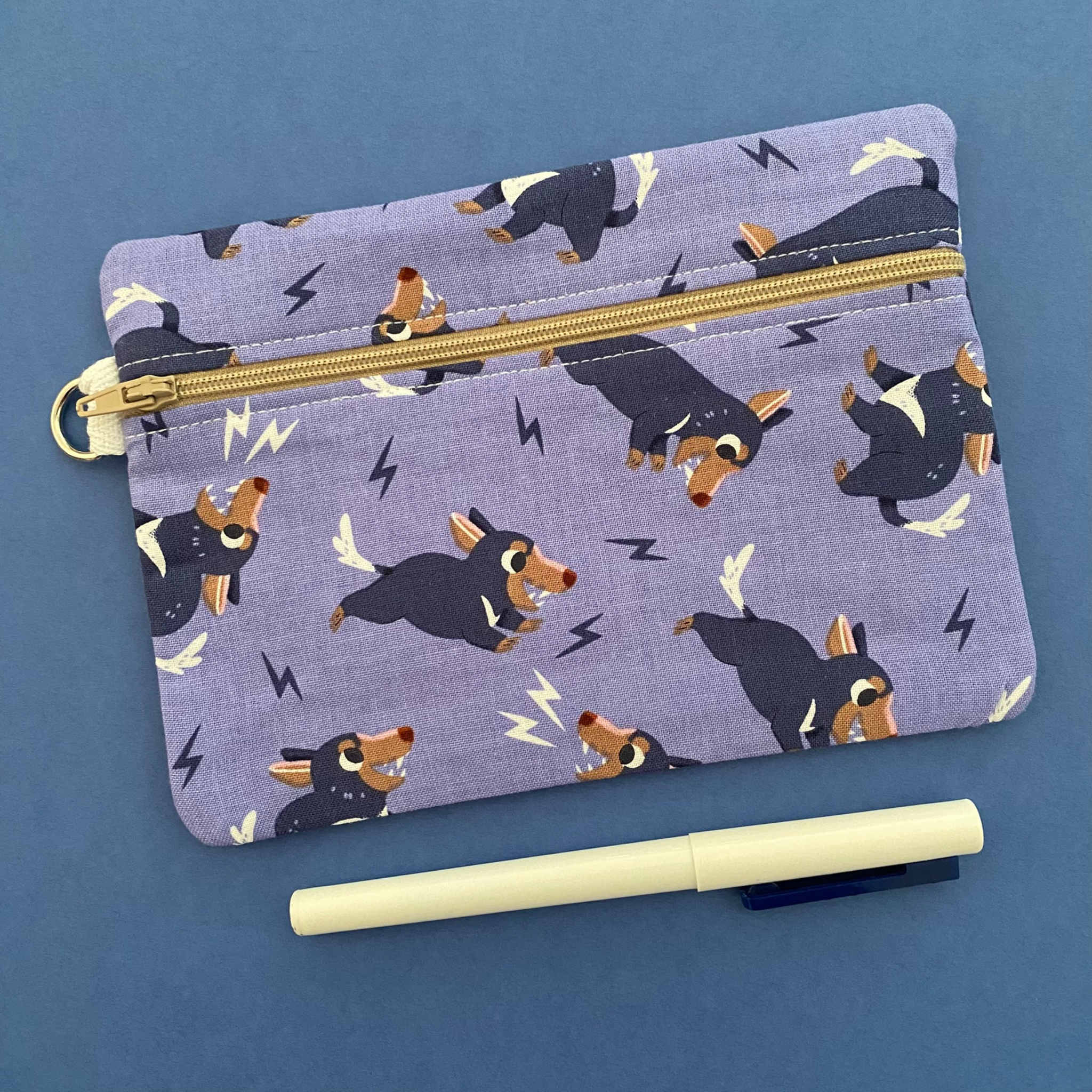 A zipper pouch featuring images of playful Tasmanian Devils.