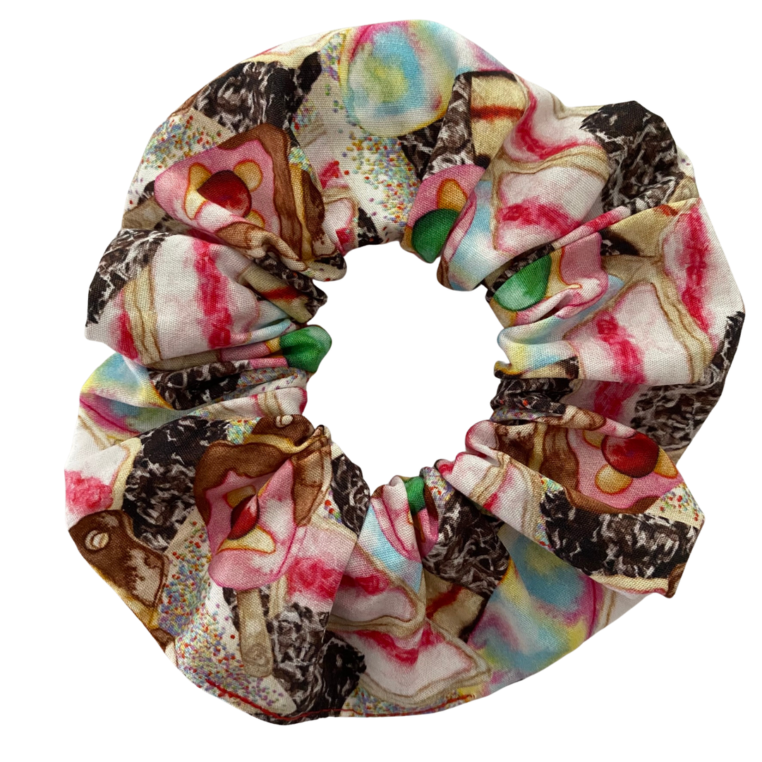 A colourful scrunchie with images of Iced Vovos, Lamington, Fairy Bread, Paddle Pop and the iconic Bubble O’Bill.