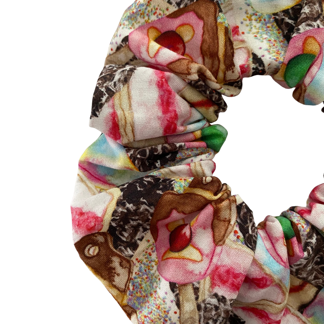 A mulitcoloured scrunchie featuring images of Iced Vovos, Lamington, Fairy Bread, Paddle Pop and the iconic Bubble O’Bill.