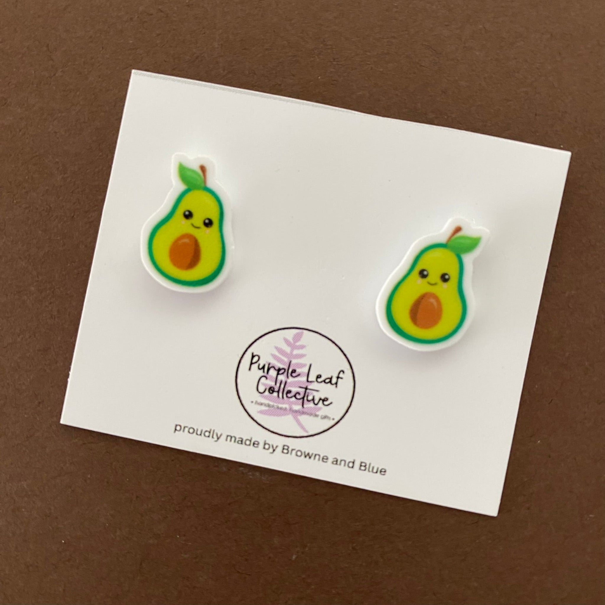 A pair of smiling Avocado novelty stud earrings. Hypoallergic Surgical Steel Posts. Printed Acrylic. Approx 15mm.