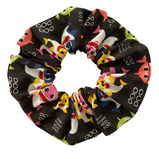 Black fabric scrunchie with colourful images of baby shark family and Doo Doo wording.
