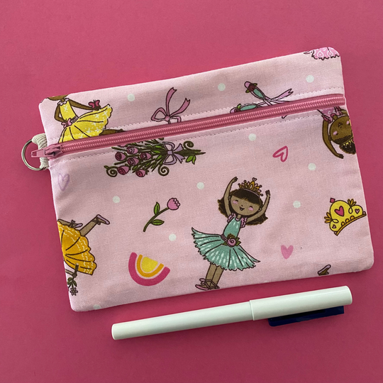 Ballet Girls zipper pouch, featuring endearing designs of ballerinas beautifully adorned with bouquets, flowers and hearts on a pink fabric.