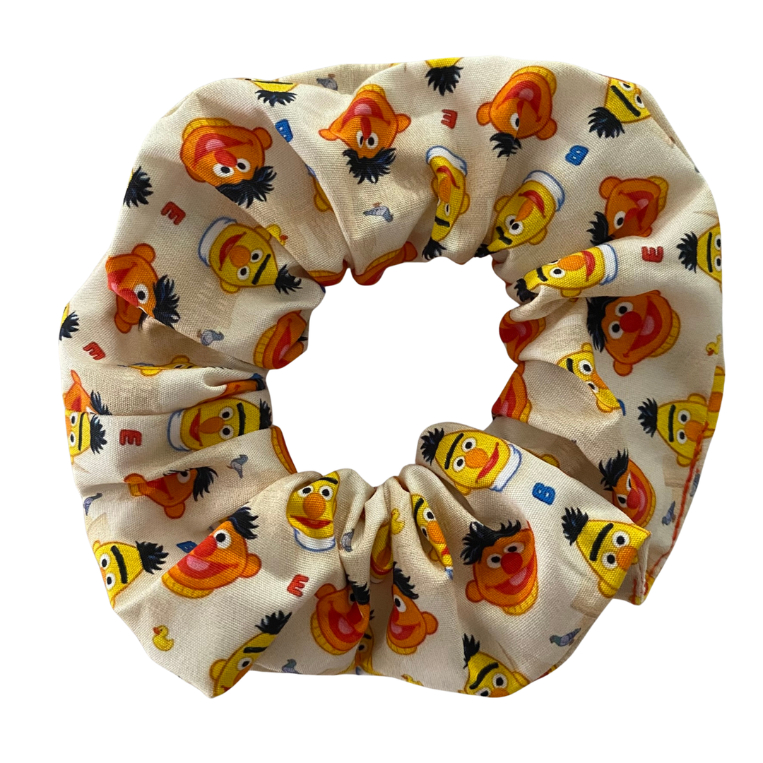 Cream coloured scrunchie featuring images of Bert& Ernie along with rubber duckie and Bernice.