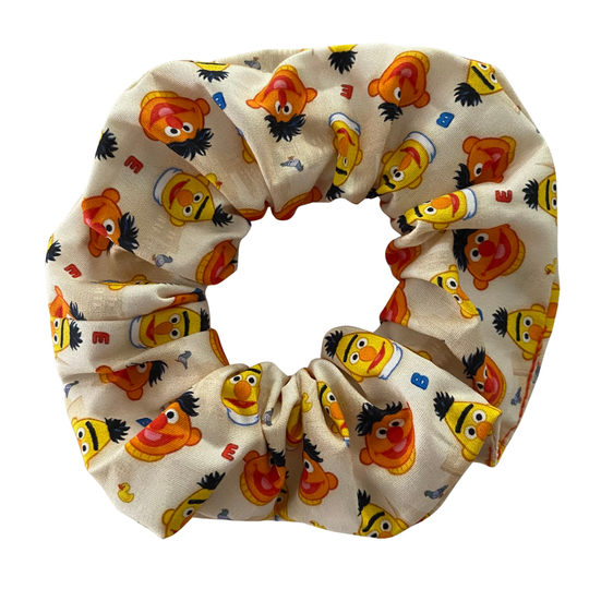 Cream coloured scrunchie featuring images of Bert& Ernie along with rubber duckie and Bernice.