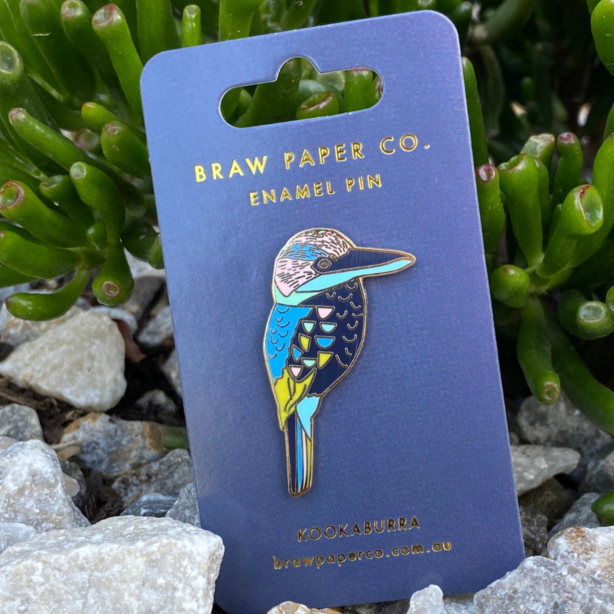 The Blue-winged Kookaburra Enamel Pin. Adorned with intricate patterns and vibrant hues.