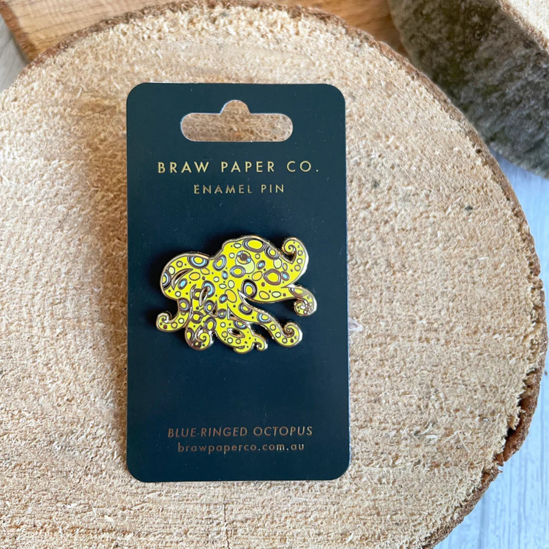 Blue ringed octopus enamel pin on a backing card.