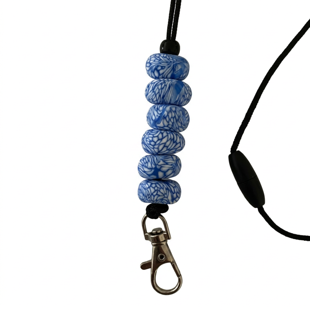 Handmade polymer clay lanyard with six hand-rolled beads in white and blue swirled pattern. Threaded on a nylon cord with a breakaway safety clasp and a silver-plated clip.