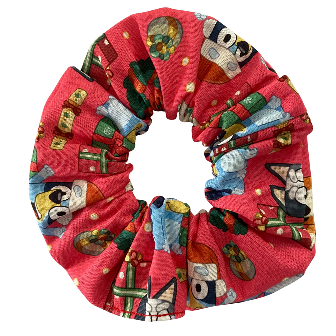 Red scrunchie with Bluey and Bingo character pattern on a white background.