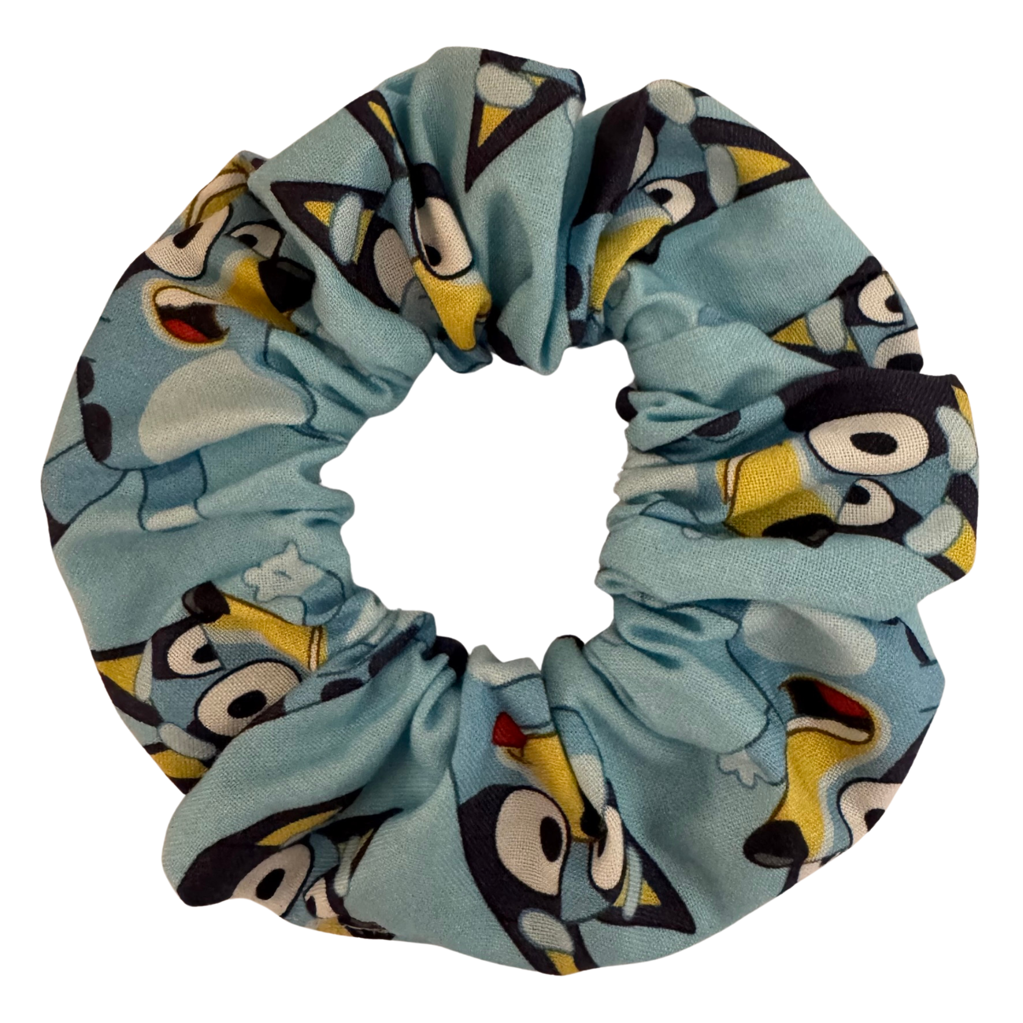 Bluey Scrunchie is handmade from soft cotton woven fabric featuring playful images of Bluey on a vibrant blue background.