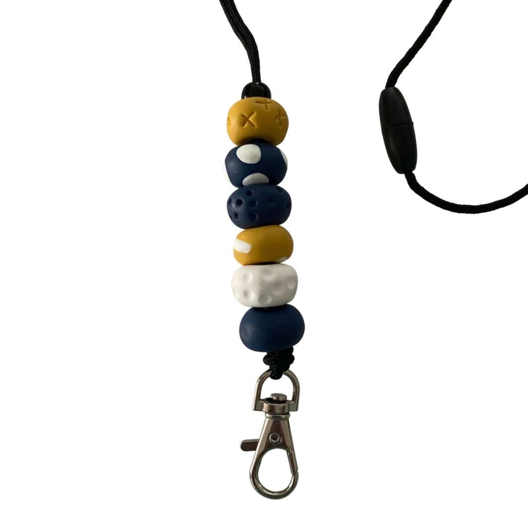 Handmade polymer clay lanyard with six hand-rolled beads in mustard, navy blue, and white. Threaded on a nylon cord with a breakaway safety clasp and a silver-plated clip.