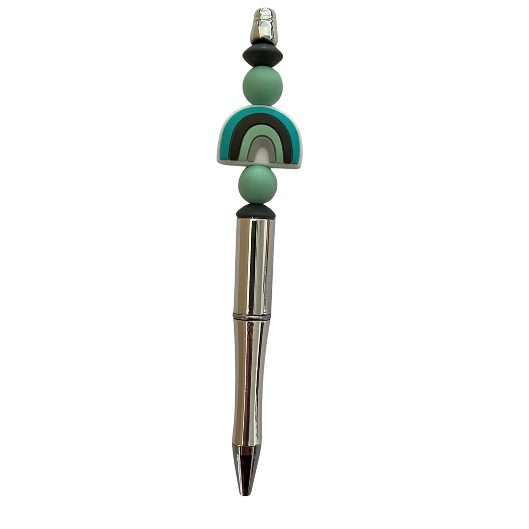 Pen with decorative mint rainbow beads on a white background.