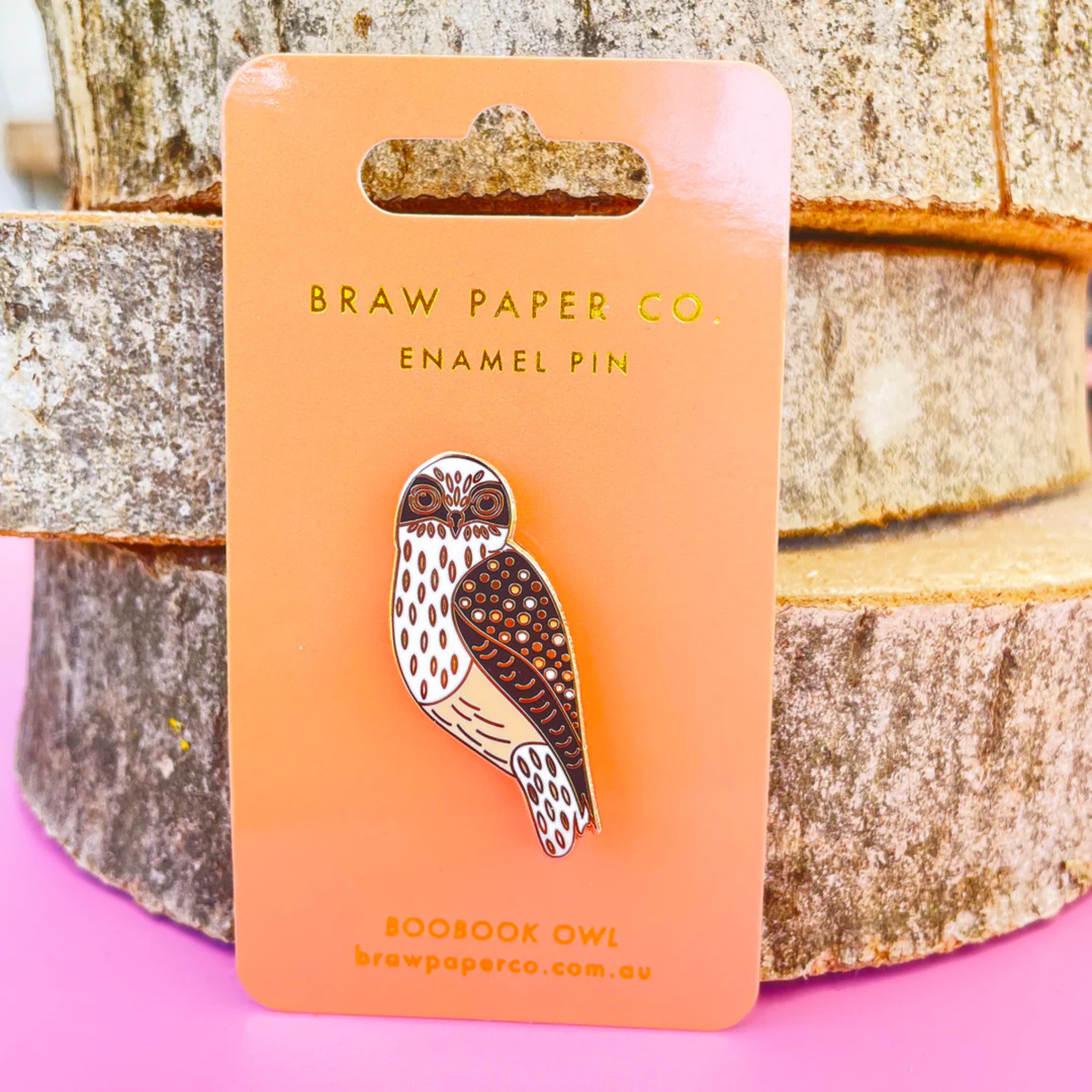 A picture of the Boobook Owl enamel pin on backing card.