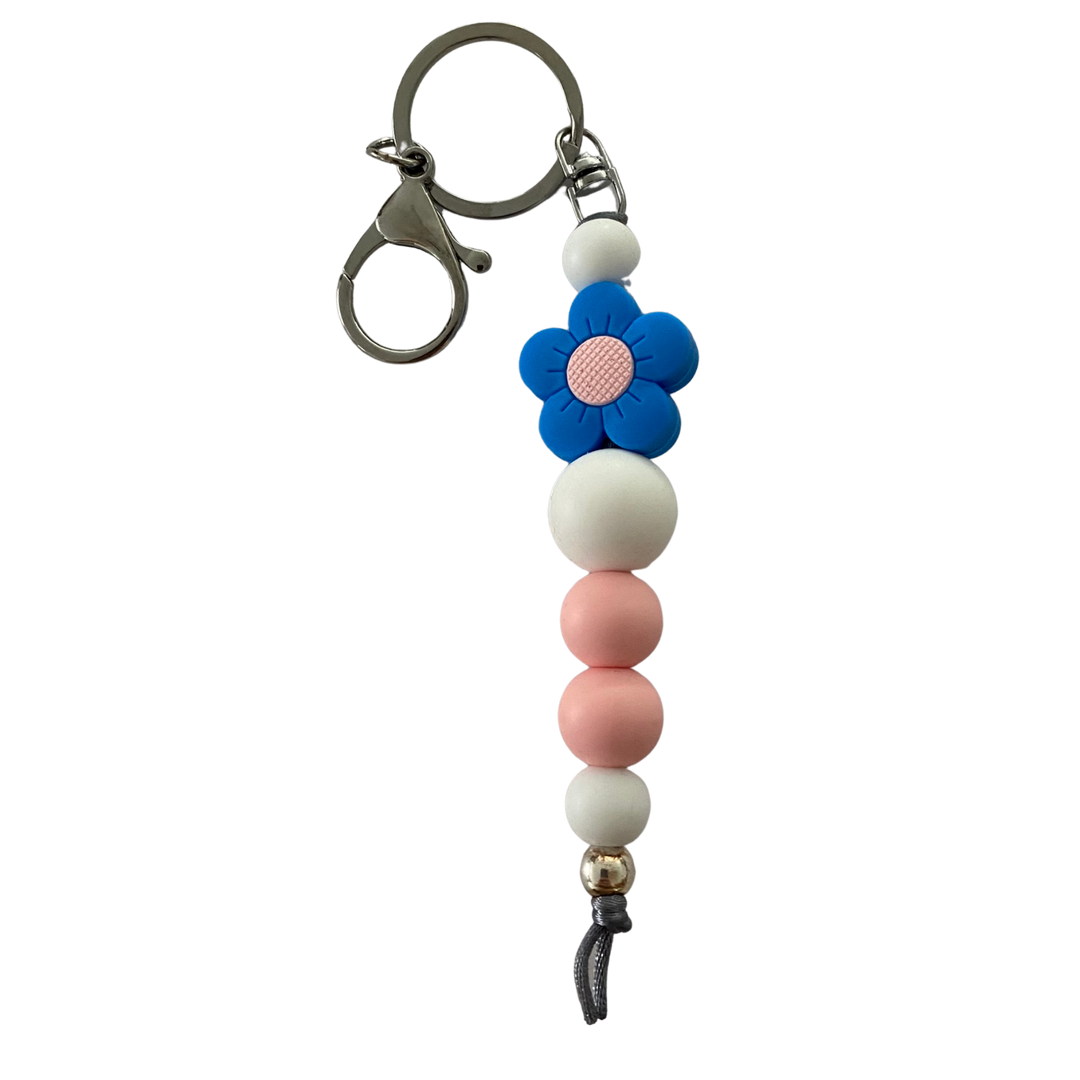 Bright Blooms Blue Flower silicone keyring with white and pink beads, a 10mm aluminum bead, and durable nylon cord. Perfect for keys or bags.