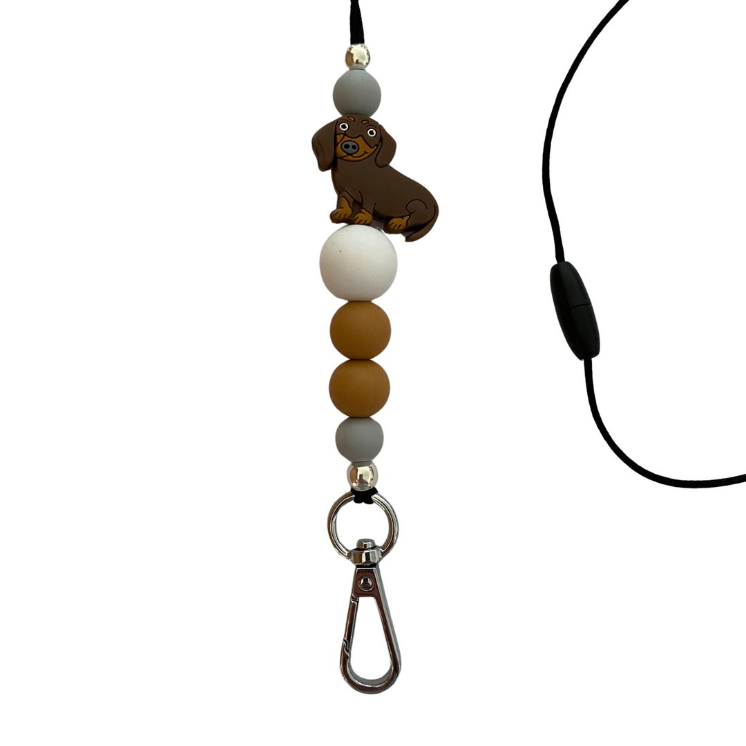 A 60cm black cord lanyard with breakaway clasp with a Brown Sausage Dog silicone bead and other coloured silicone beads.
