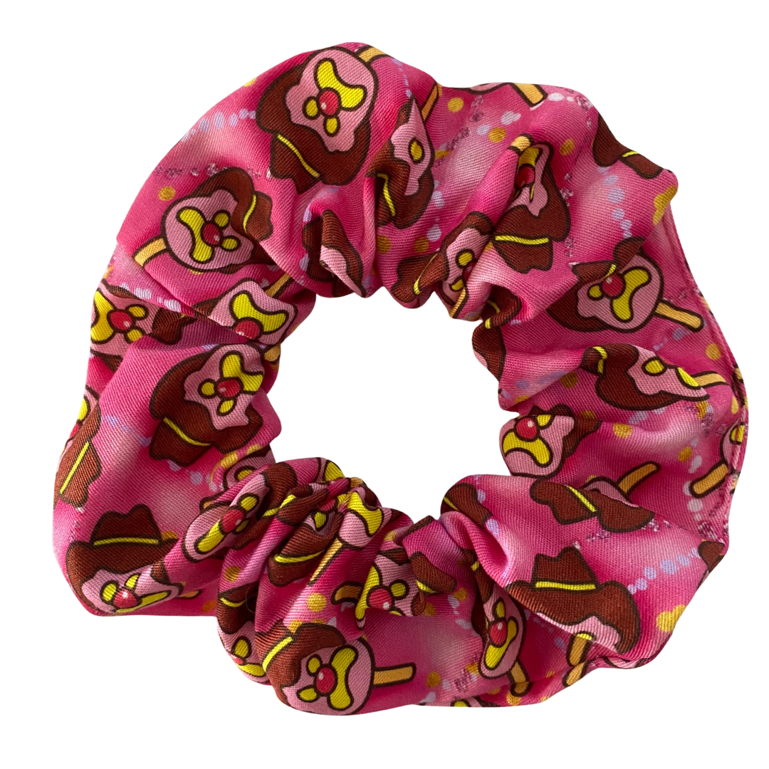 Hot pink scrunchie with Bubble O'Bill character pattern on a white background.