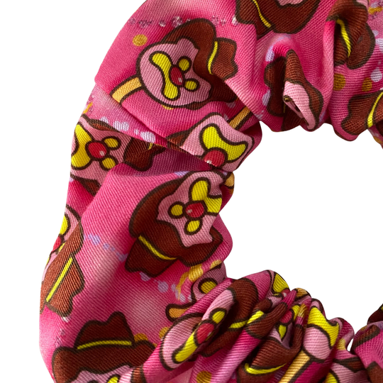 Bubble O'Bill character pattern on a hot pink fabric scrunchie.